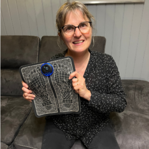 woman showing Nooro EMS Foot Massager